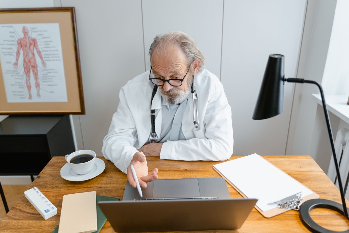 Doctor reviewing security information on a laptop in a medical office