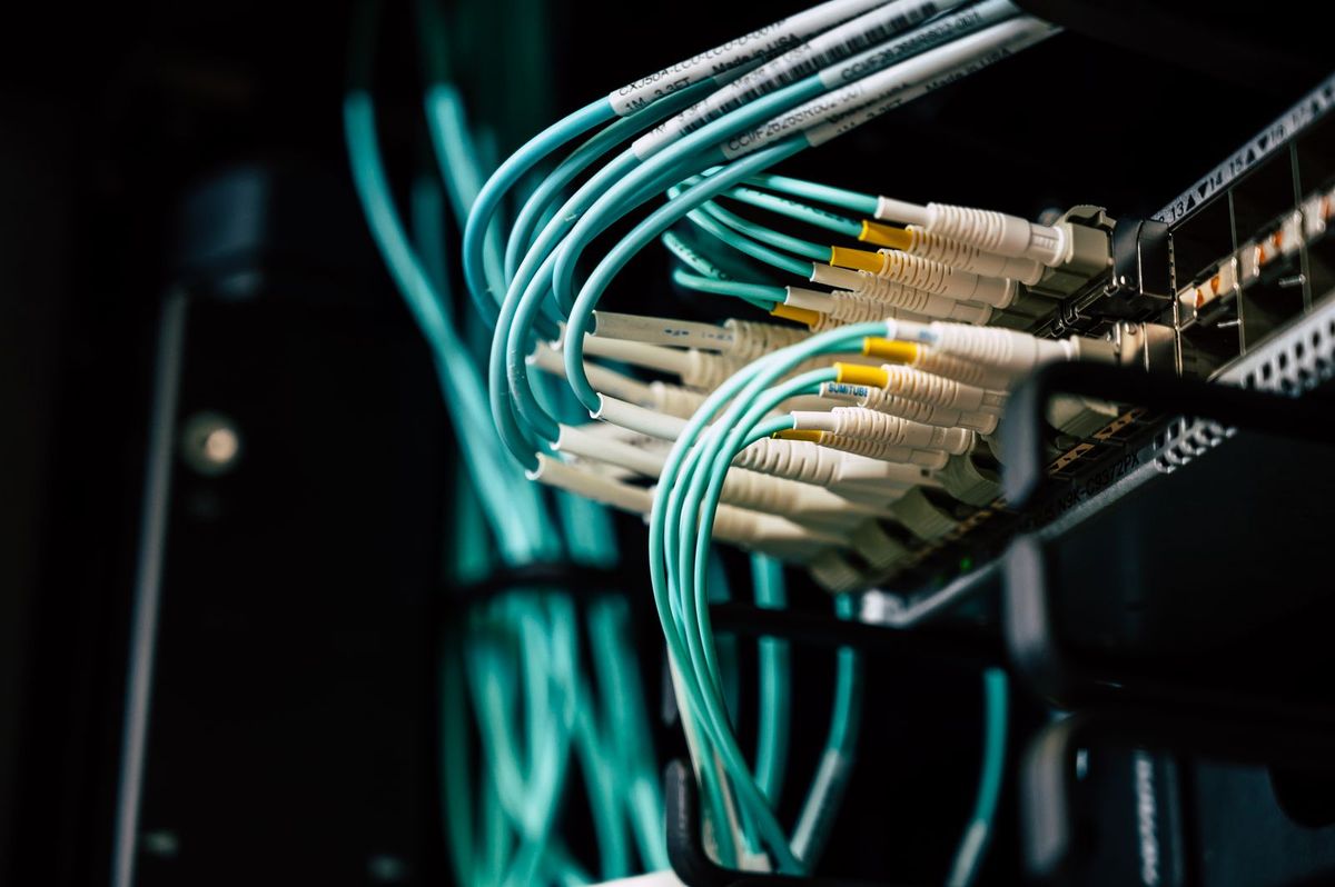 Fiber-optic cables plugged into network equipment